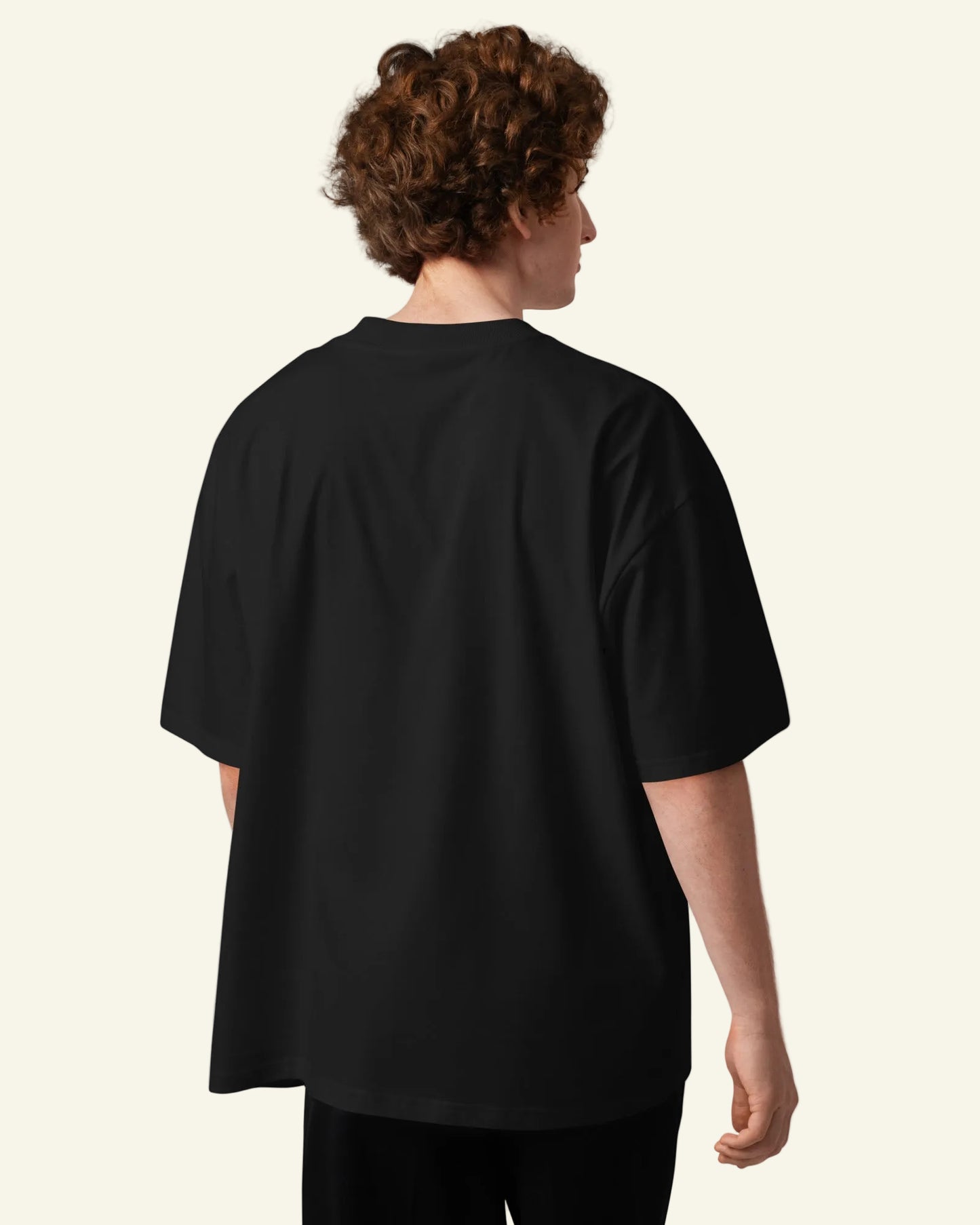 Person wearing a black oversized t-shirt on a white background