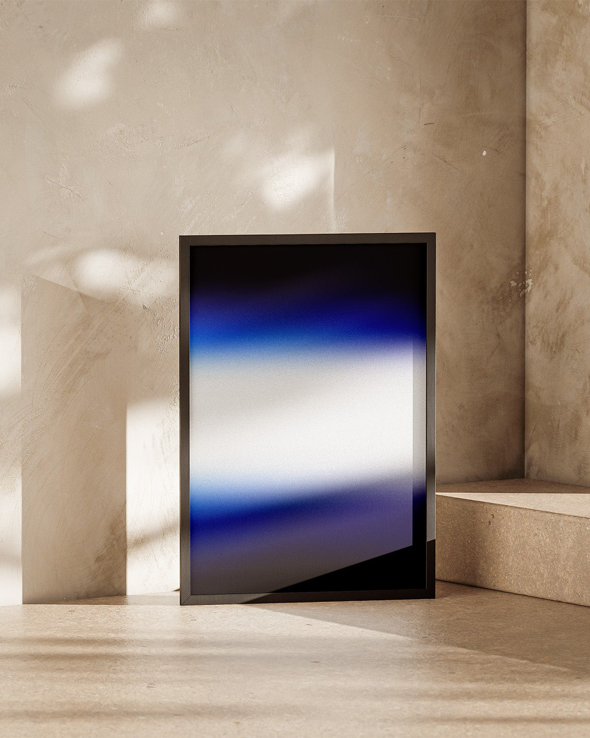 Abstract art piece with a gradient of blue, white, and black on a textured beige wall.
