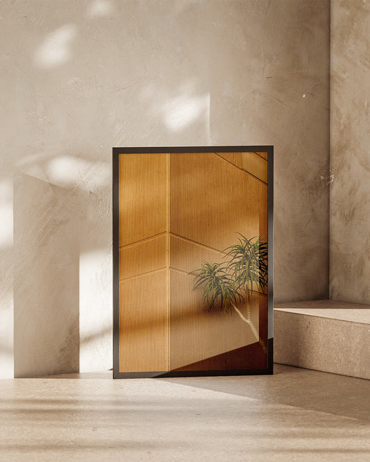 Modern interior with a glass door featuring a plant design, set against a neutral wall.