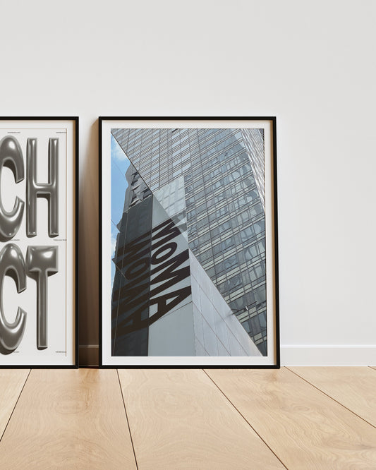Two framed prints on a wall, one with 'ARCHITECT' text and the other with architectural design.
