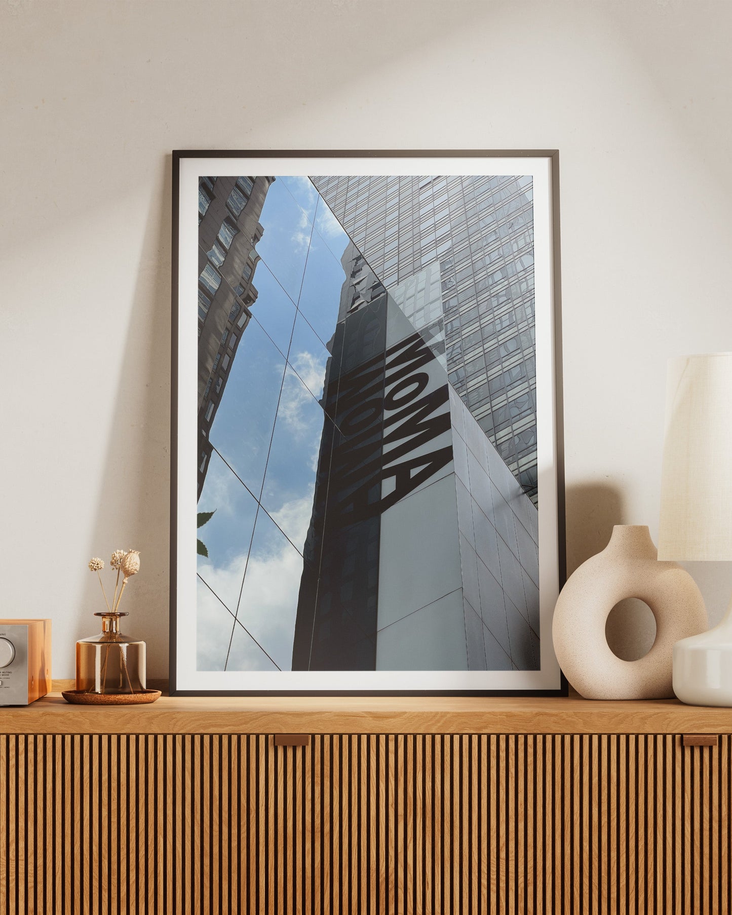MoMa Print framed on Wooden console table with decorative items against a beige wall