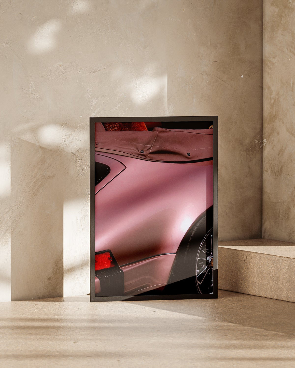 Close-up of a classic Porsche 911 rear quarter panel with satin rose metallic paint and wide rear fender.