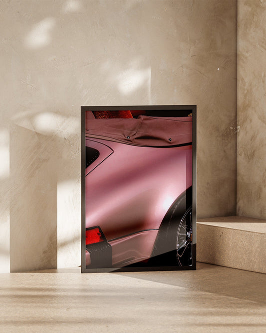 Close-up of a classic Porsche 911 rear quarter panel with satin rose metallic paint and wide rear fender.