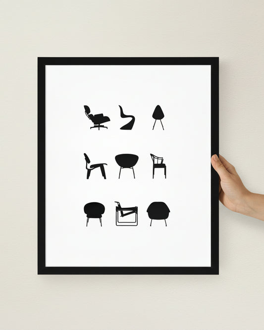 Framed poster with black and white illustrations of chairs on a white wall.