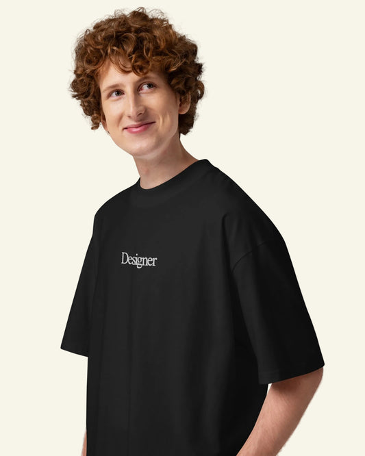 Person wearing a black t-shirt with 'Designer' text on a white background